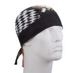 A black bandana is worn on a mannequin head featuring a diamond pattern on one side and colorful designs on the other showcasing a stylized graphic print and long ties at the back.