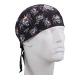 A black bandana featuring skulls and spider designs is displayed on a plain white mannequin head with ties hanging from the back in a neutral setting.