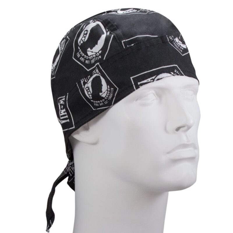 A black bandana with white printed designs rests on a mannequin's head  showcasing various symbols and phrases  suggesting a style associated with casual or outdoor wear.