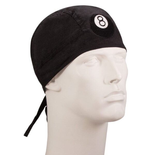 A black fabric cap with a circular white emblem featuring the number eight is resting on a plain white mannequin head in a neutral setting without additional context.