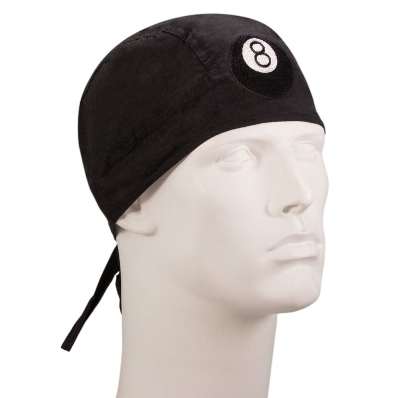 8 Ball Embroidered Head Wrap A black fabric cap with a circular white emblem featuring the number eight is resting on a plain white mannequin head in a neutral setting without additional context.