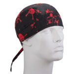 A black bandana with red skull and crossbones patterns is worn on a mannequin's head showcasing a distinct pirate-like design in a neutral setting.