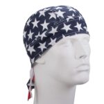 A white mannequin head displays a navy bandana covered in white stars tied at the back suggesting a casual or patriotic style in a simple  neutral setting.