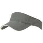 A green visor cap rests flat with a wide brim to shield the eyes made of fabric with a clean design suitable for outdoor activities or sports in sunny conditions.