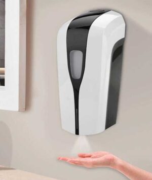 A wall-mounted soap dispenser is releasing liquid soap into a person's outstretched hand in a well-lit indoor setting  highlighting hygiene practices in a modern environment.