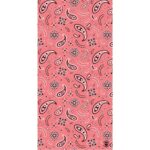 A pink fabric covered with intricate paisley patterns and floral designs creates a vibrant visual texture showcasing contrasting black and white details against a warm background.